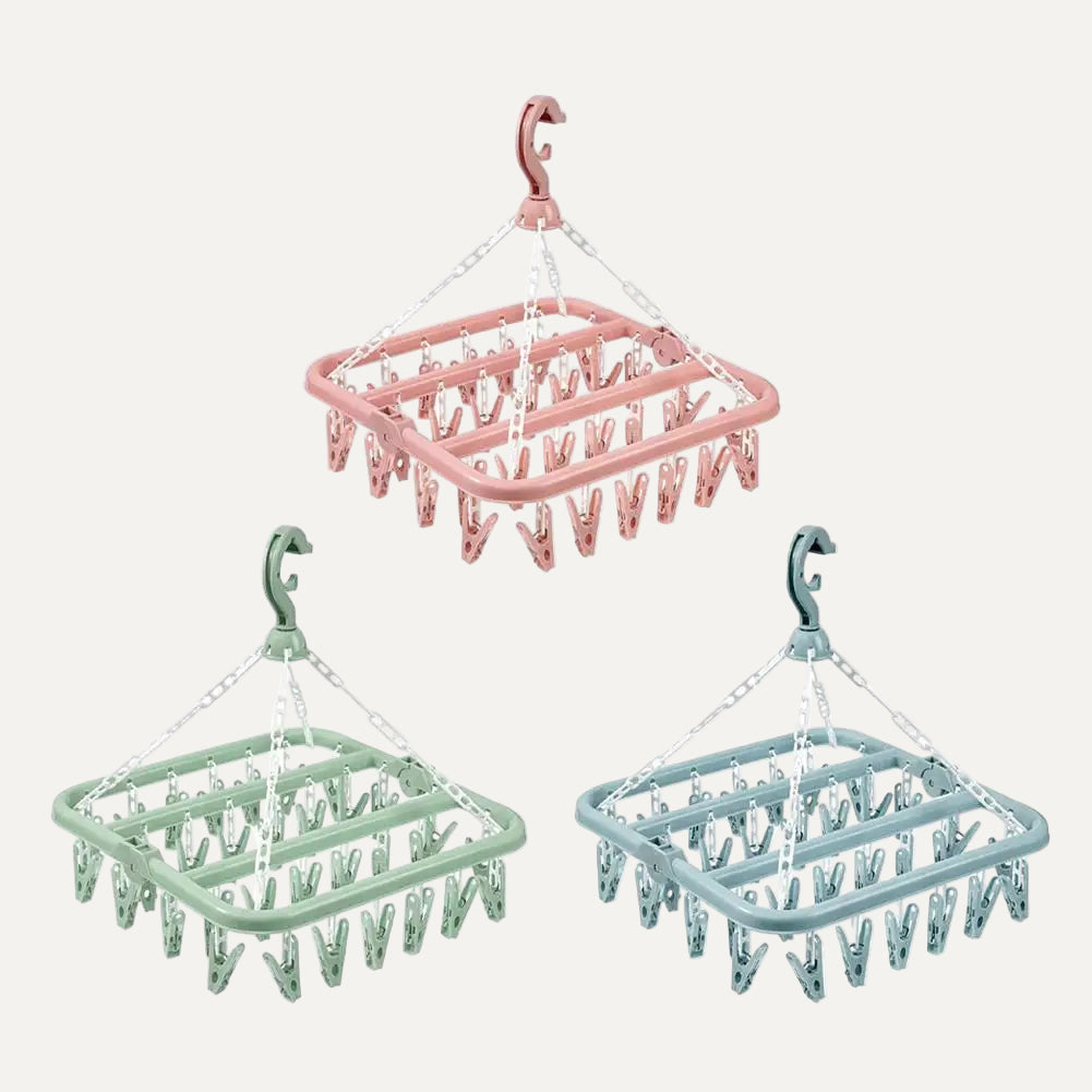 3 Clothespin racks with multiple clips on a white background
