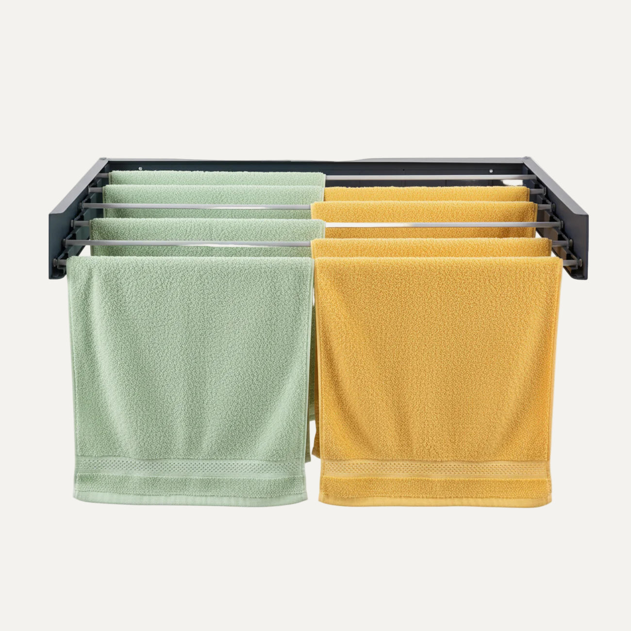 Black towel rack/airer with green and yellow towels on a white background