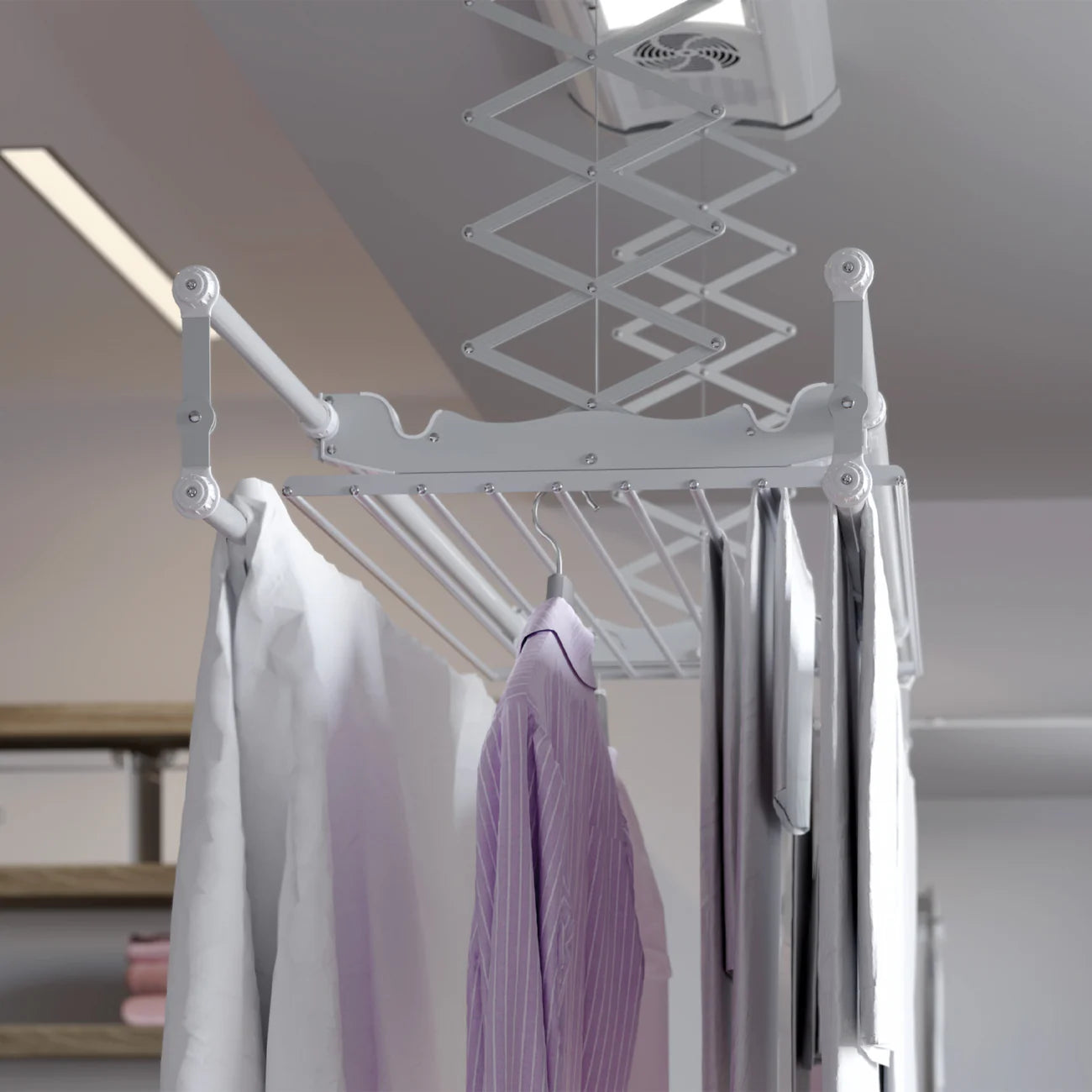 Ceiling-mounted clothes dryer with hanging clothes in a room.