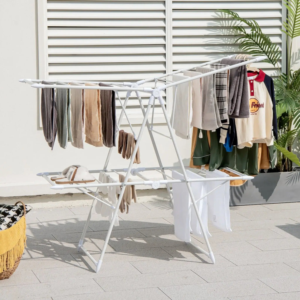Clothes drying on a white metal drying rack outdoors.