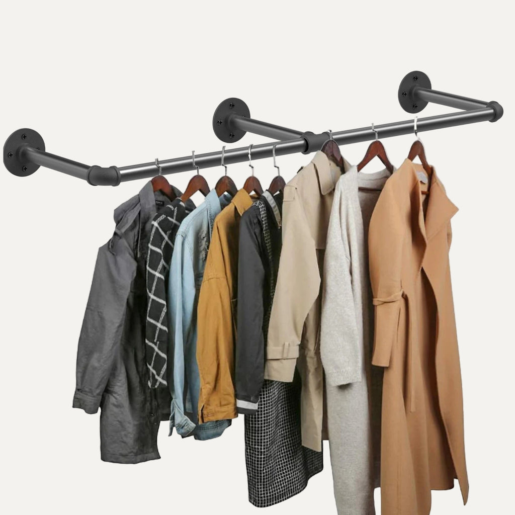 Clothing rack with various jackets and coats hanging on it against a white background