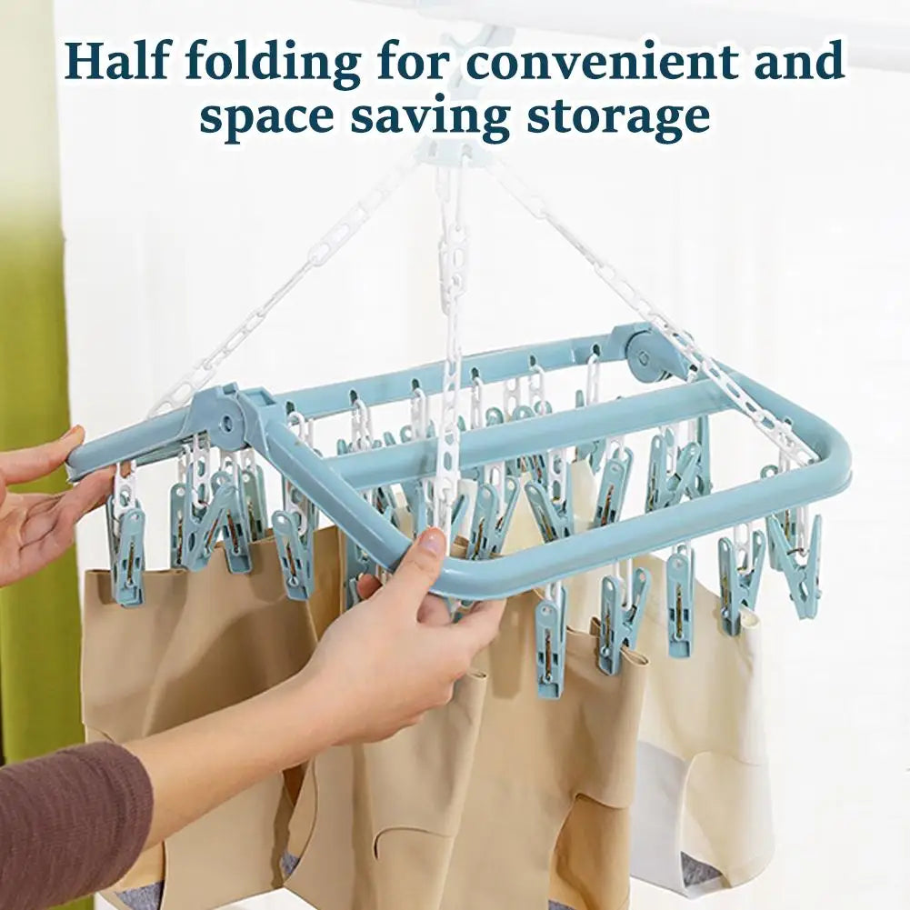 Foldable Multi-clip drying rack with clips and a person using it.