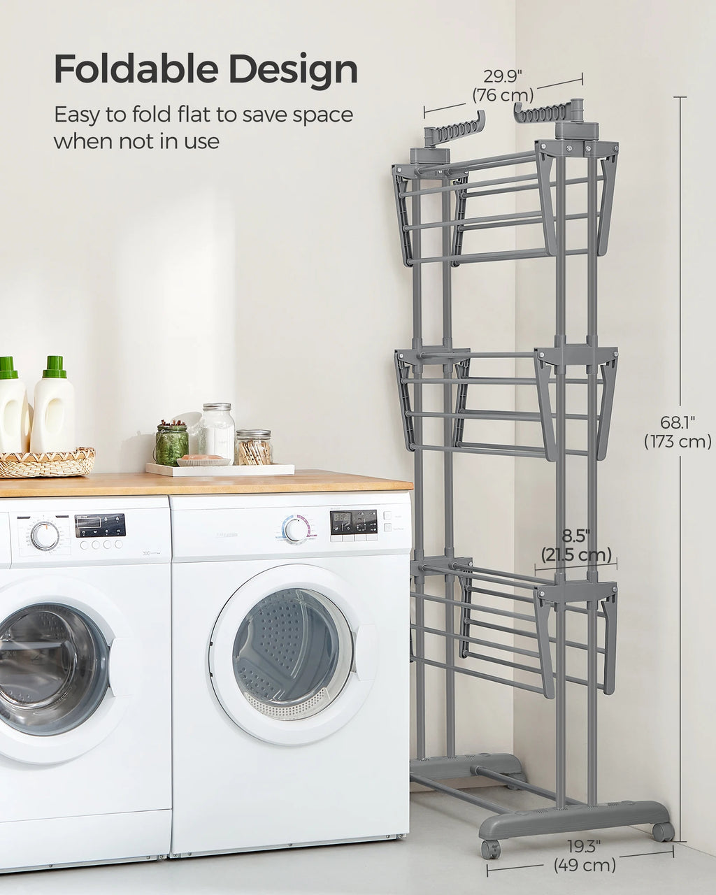 Foldable drying rack next to a washing machine with dimensions displayed