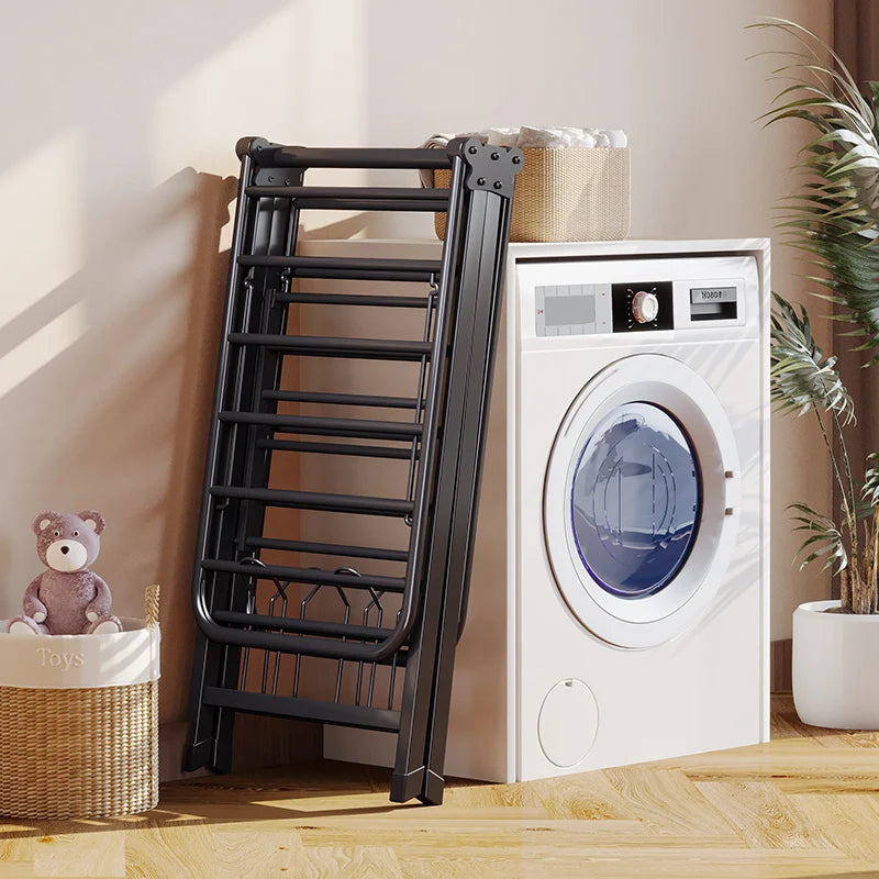 Folded clothing drying rack in a minimalistic room next to a washer