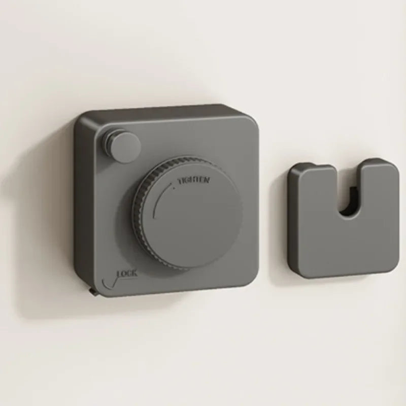 Gray retractable clothesline mechanism on a beige background