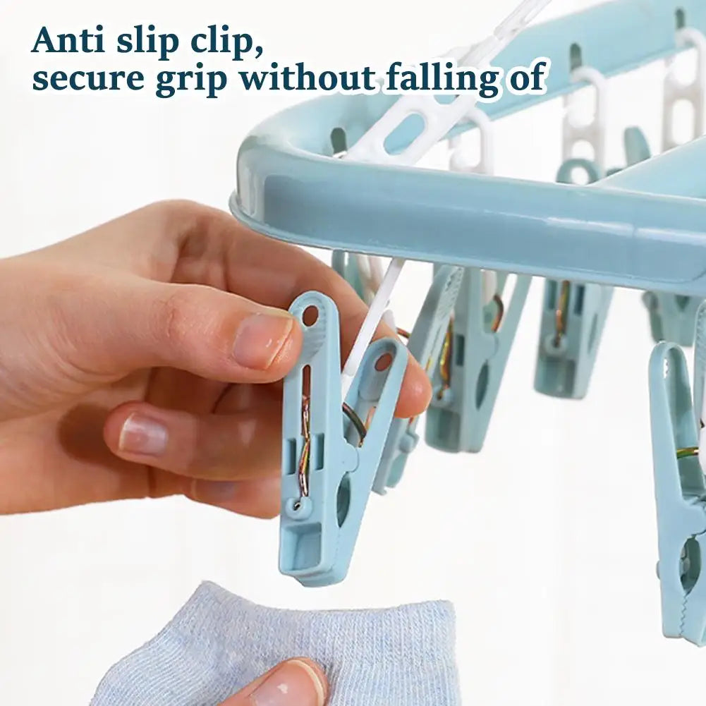 Hand holding a blue clothespin with an anti-slip clip feature, on a white background.