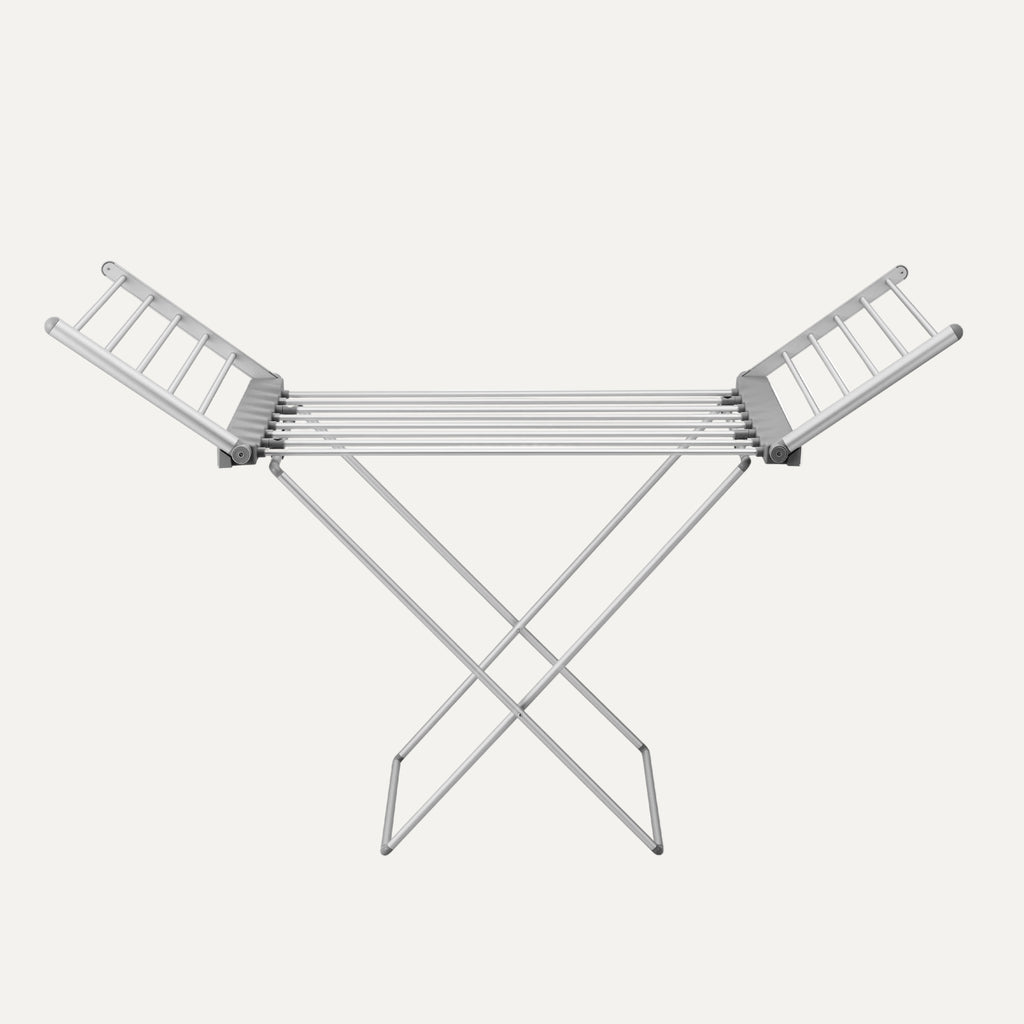 Heated metal clothes drying rack on a white background
