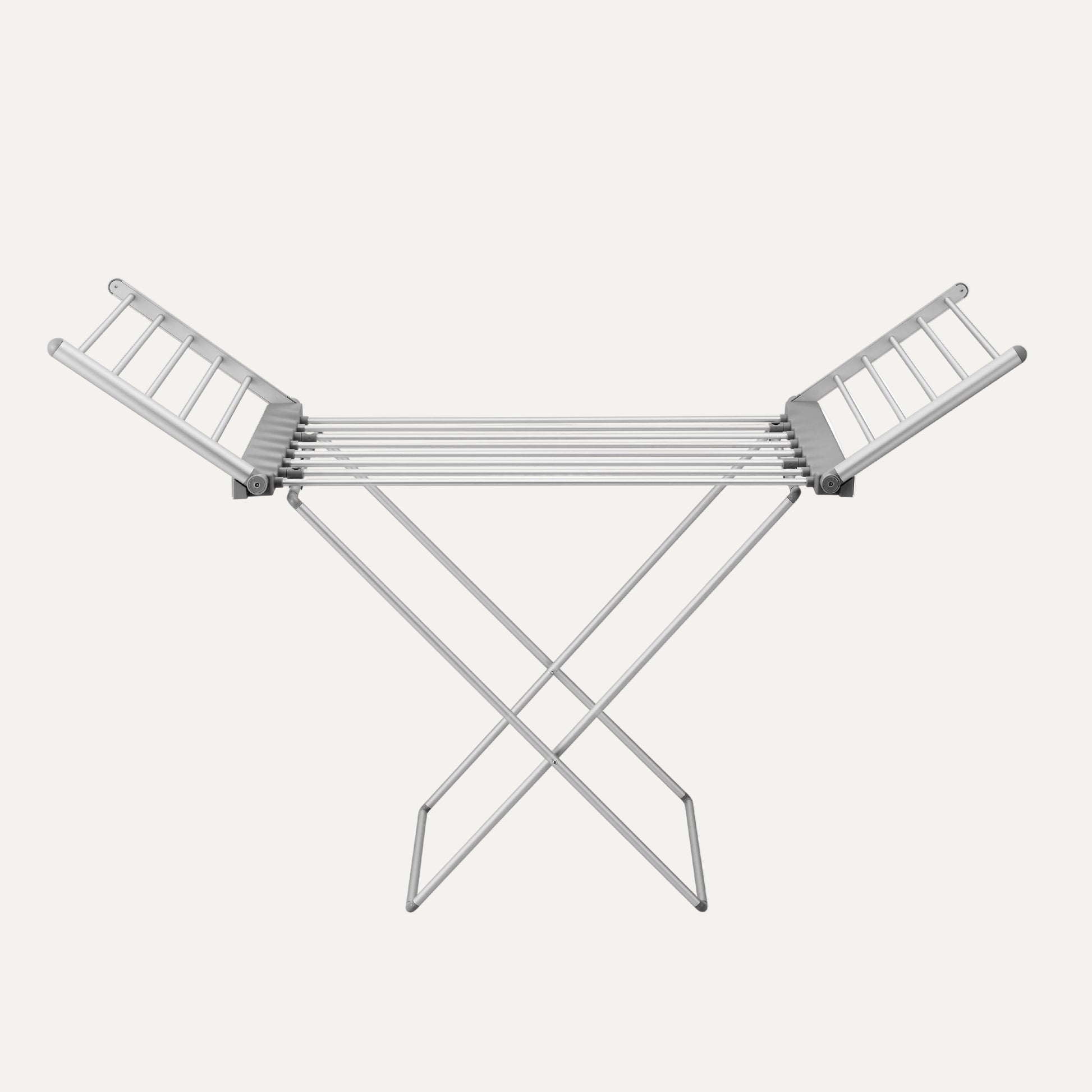 Heated metal clothes drying rack on a white background