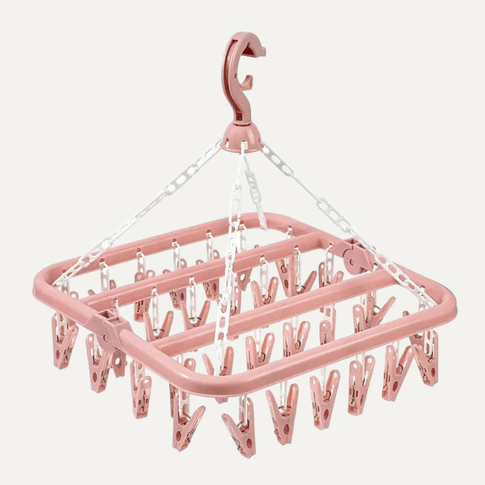 Pink clothespin rack with multiple clips on a white background