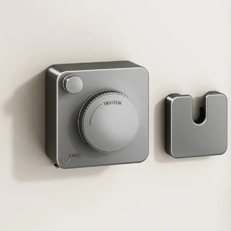 Silver retractable clothesline mechanism on a beige background