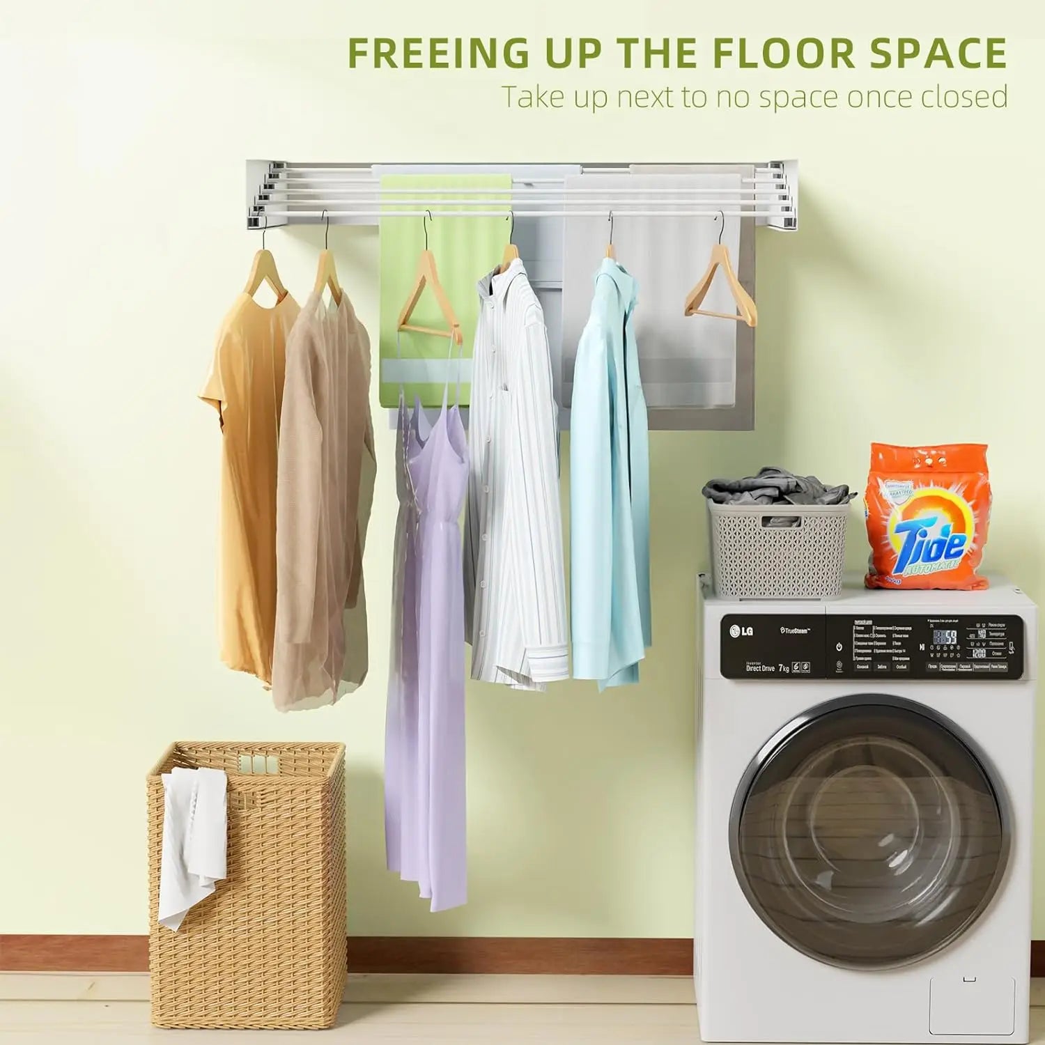 Wall-mounted clothes dryer/airer with hanging clothes next to a washing machine and Tide detergent.