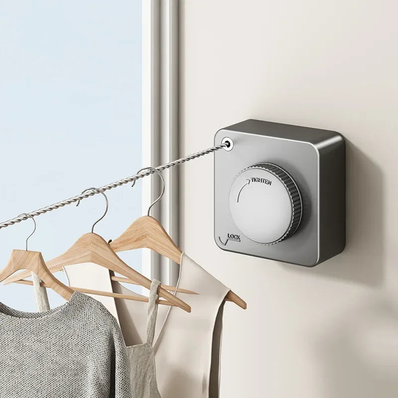 Wall-mounted clothes dryer with hangers and clothing in a room.