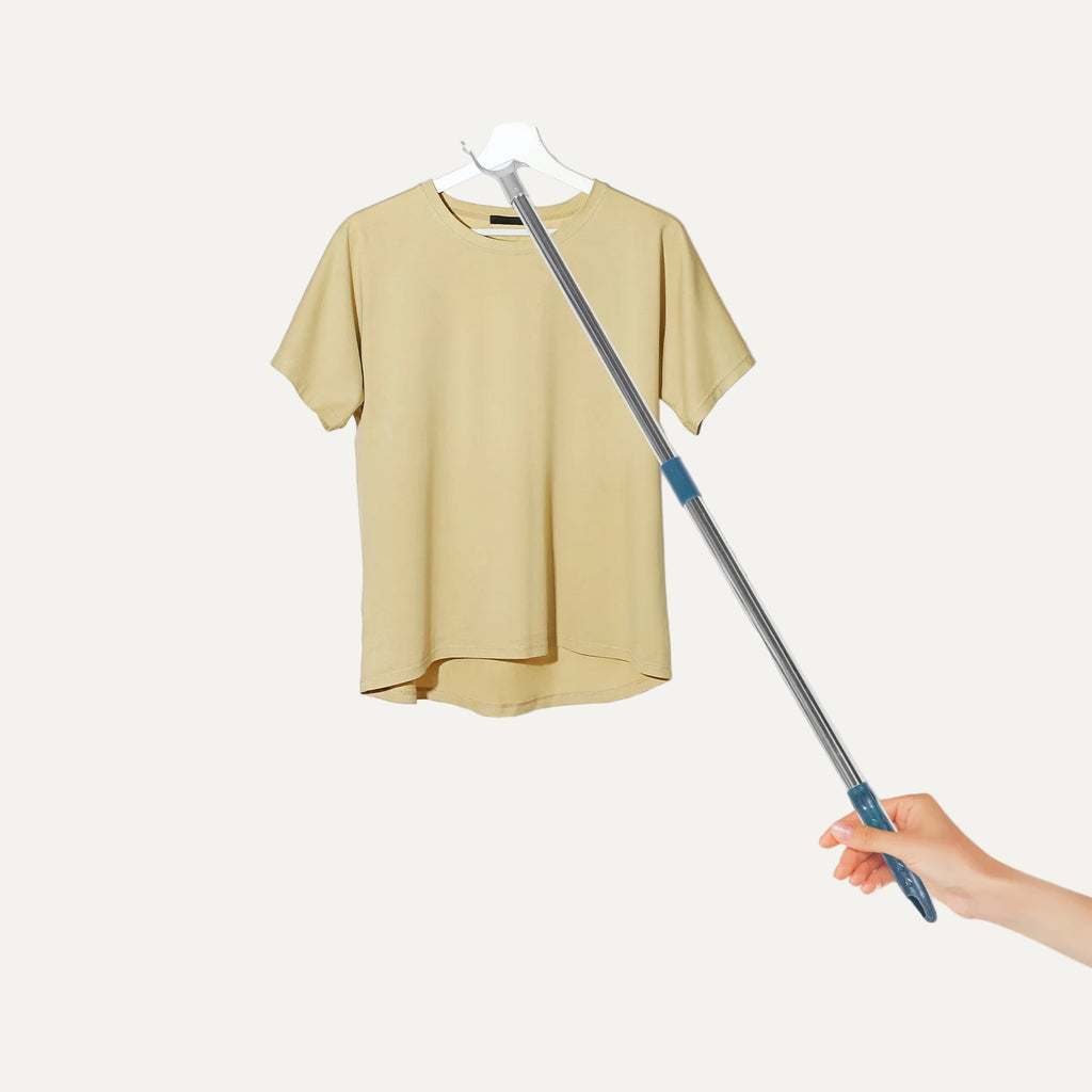 Yellow shirt on a hanger with a telescopic rod against a white background