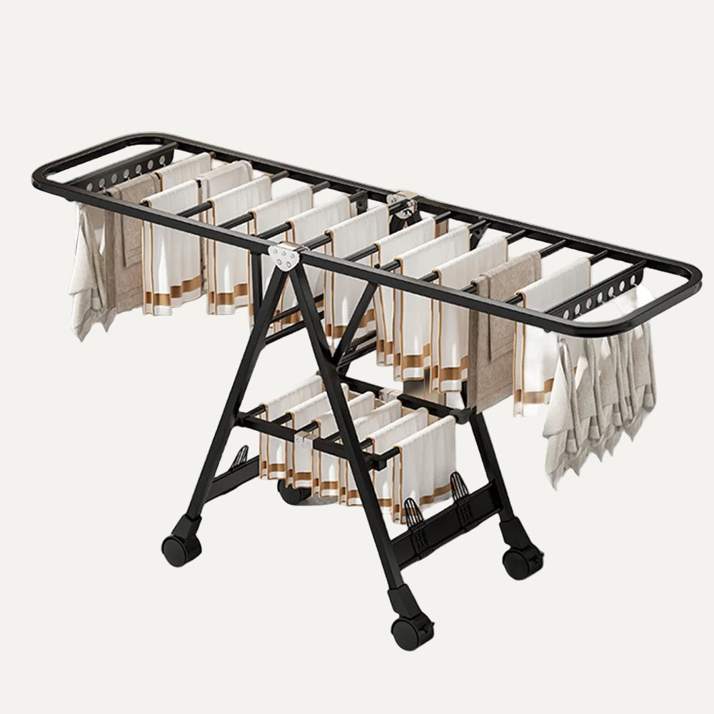 black drying rack/clothes airer with towels on it on a white background